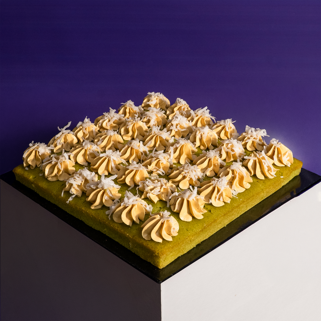 Square pandan gula melaka cake bites on a board, cut into shareable portions — Elevete Patisserie