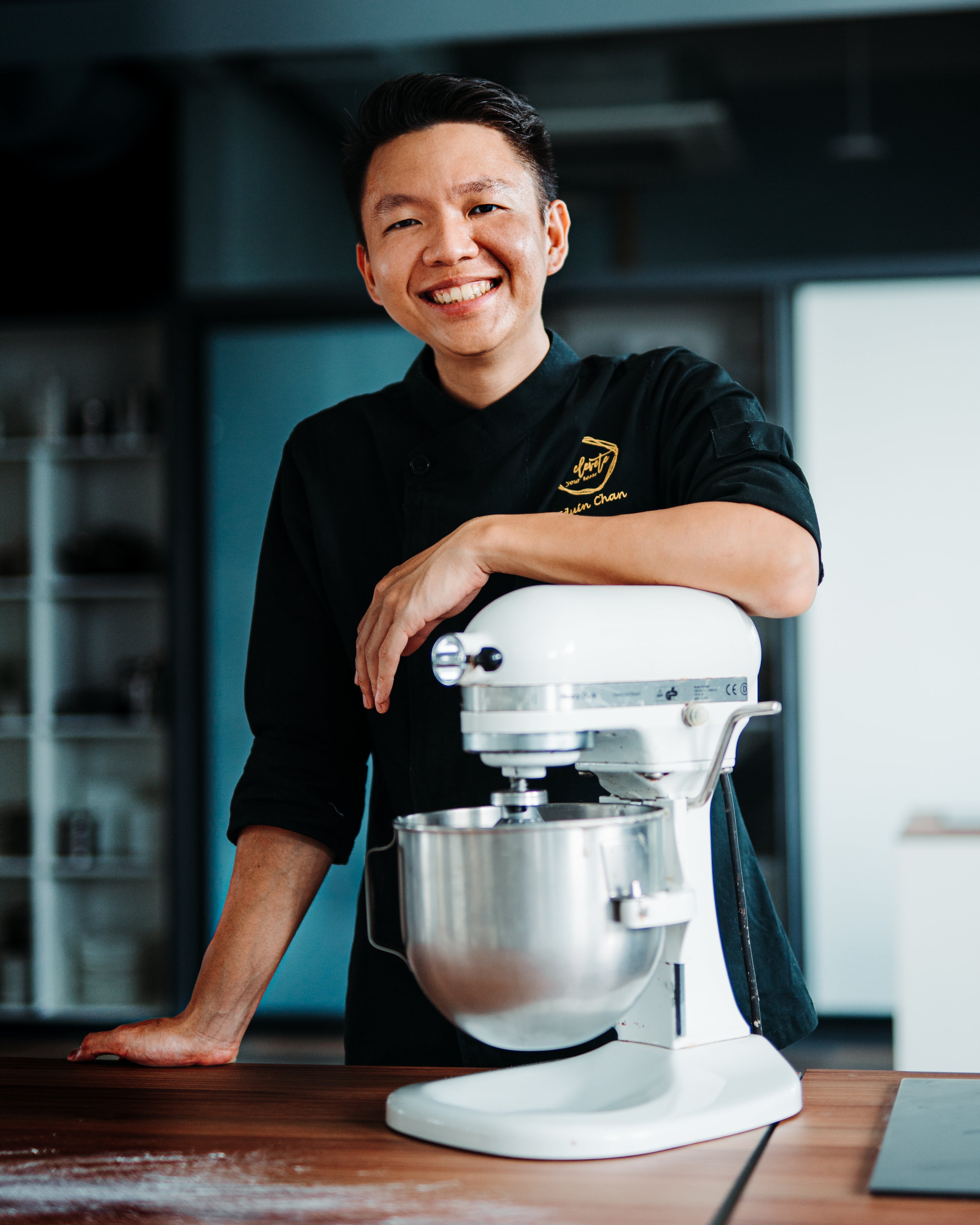 Pak Win in the Elevete Patisserie kitchen beside a stand mixer — Elevete Patisserie KL