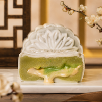 Pandan gula melaka snowskin mooncake cut open, showing the green pandan filling — Elevete Patisserie KL
