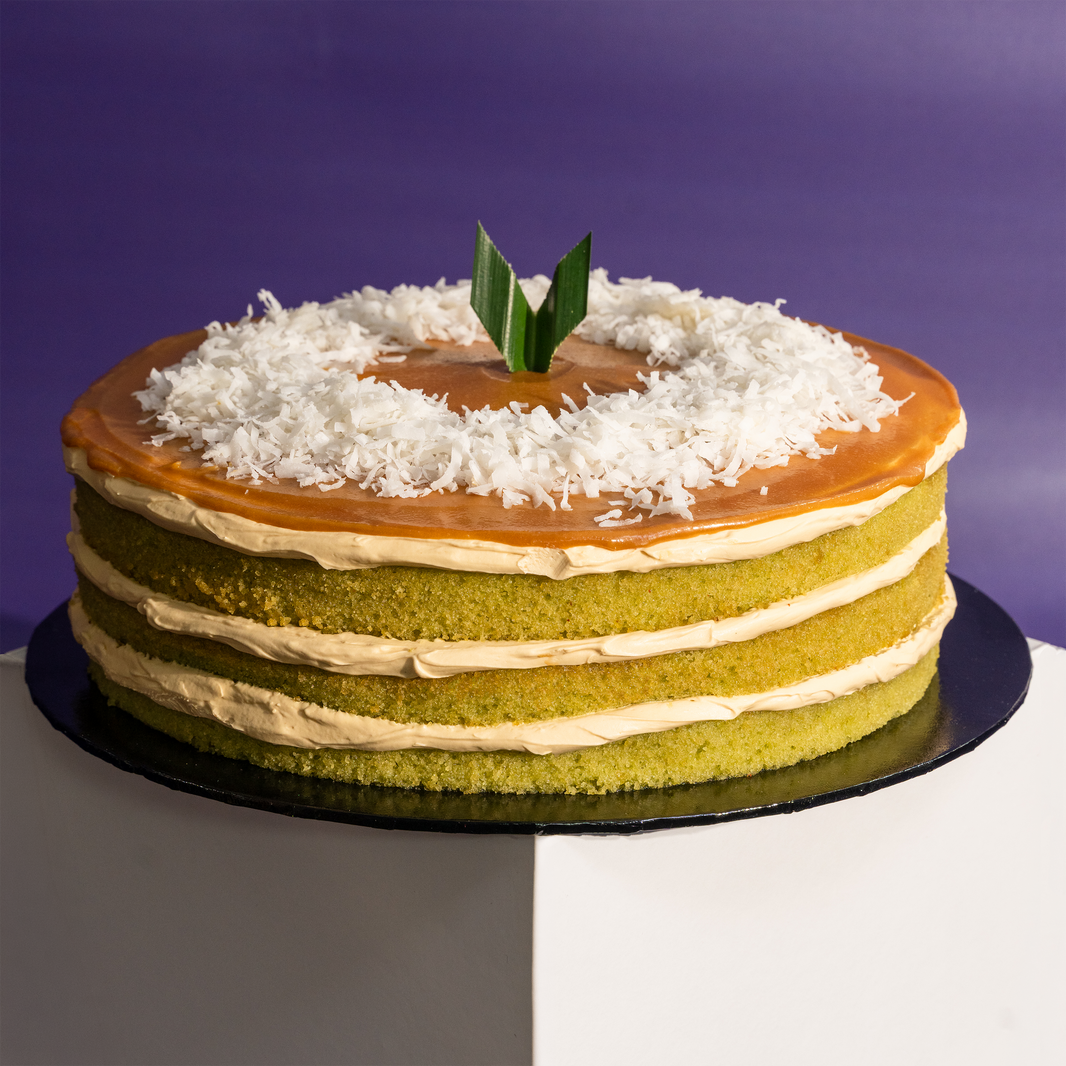 The Locale pandan gula melaka cake, whole, topped with gula melaka glaze and shredded coconut — Elevete Patisserie