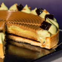 Pandan coffee tart cross-section, pandan pastry cream layered against dark coffee — Elevete Patisserie